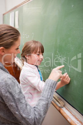 Portrait of a teacher and a pupil making an addition