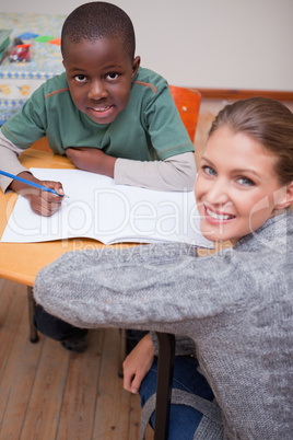 Portrait of a teacher explaining something to a young schoolboy