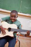Portrait of a schoolboy playing the guitar