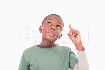 Boy pointing at something above him