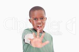 Boy saying stop with his hand