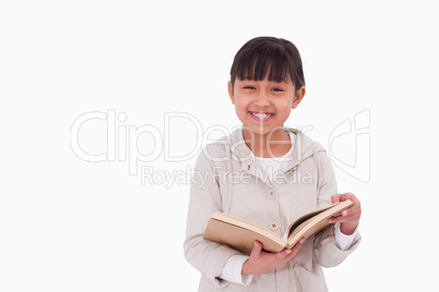 Smiling girl reading a book