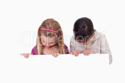 Girls looking at a blank panel