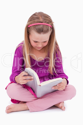 Portrait of a cute girl reading a book