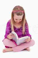 Portrait of a cute girl reading a book