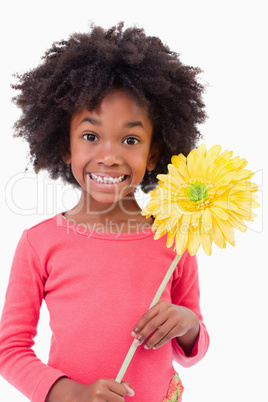 Portrait of a smiling girl holding a flower