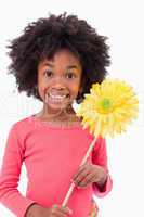 Portrait of a smiling girl holding a flower