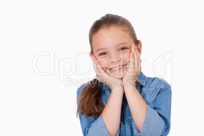 Girl posing with her hands under her chin