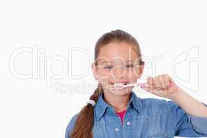 Healthy girl brushing her teeth