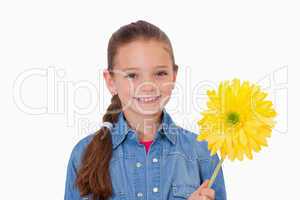 Girl holding a yellow flower