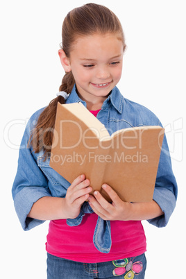 Portrait of a calm girl reading a book