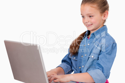 Smiling girl using a laptop