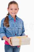 Portrait of a girl holding a gift box