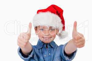 Girl with a Christmas hat and the thumbs up