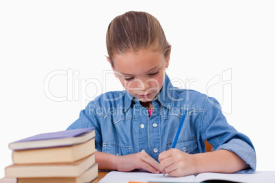 Serious girl writing on a notebook