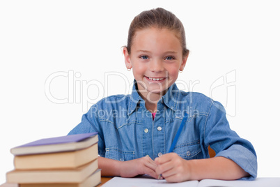 Smiling girl writing on a notebook