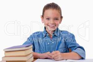 Smiling girl writing on a notebook