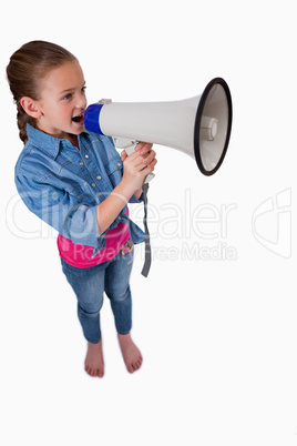 Portrait of a cute girl speaking through a megaphone