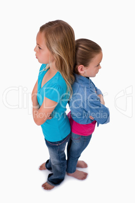 Portrait of girls standing back to back