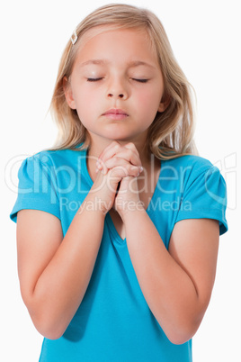 Portrait of a young girl praying