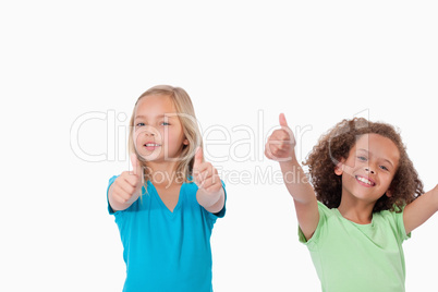 Cheerful girls with the thumbs up