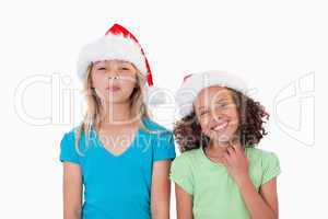 Cheerful girls with Christmas hats