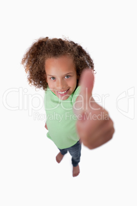 Portrait of a smiling girl with the thumb up