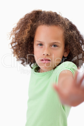 Portrait of a girl saying stop with her hand