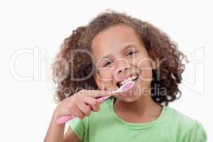 Cute girl brushing her teeth