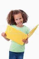 Portrait of a smiling girl reading a fairy tale