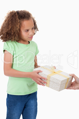 Portrait of a young girl receiving a gift