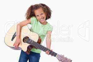 Happy girl playing the guitar