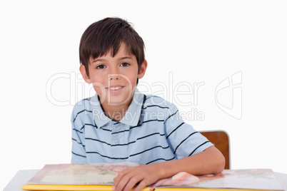 Cute boy reading a book