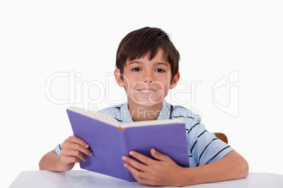 Happy boy reading a book