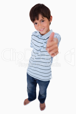 Portrait of a boy smiling at the camera with the thumb up