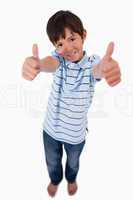 Portrait of a boy smiling at the camera with the thumbs up