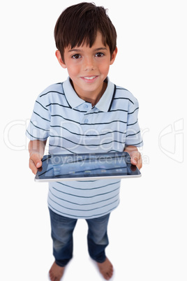 Portrait of a happy boy using a tablet computer