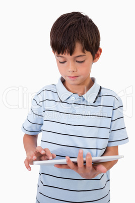 Portrait of a cute boy using a tablet computer