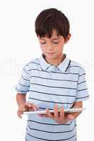 Portrait of a cute boy using a tablet computer