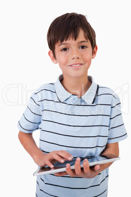 Portrait of a cute little boy using a tablet computer