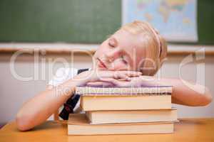 Girl sleeping on her books