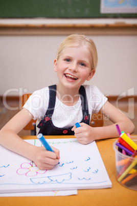 Portrait of a smiling girl drawing