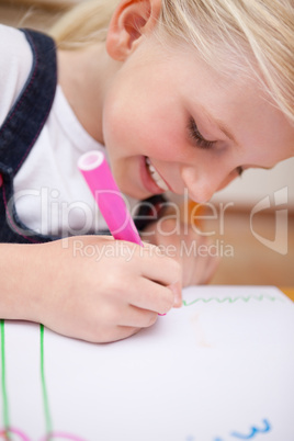 Portrait of a delighted girl drawing