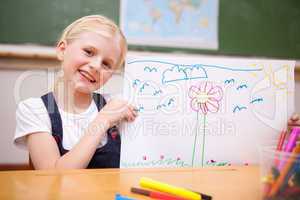 Smiling girl showing her drawing