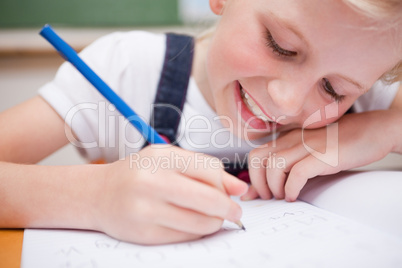 Close up of a schoolgirl writing something