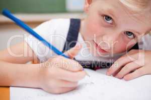 Close up of a serious schoolgirl writing something