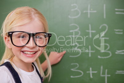 Smart schoolgirl pointing at something