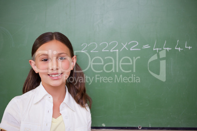 Schoolgirl posing in front of a chalkboard