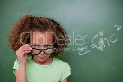 Schoolgirl looking above her glasses