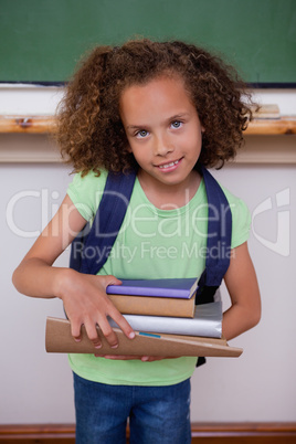 Portrait of a schoolgirl holding books